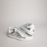 Angled pair of women’s silver goat leather Milano sneakers
