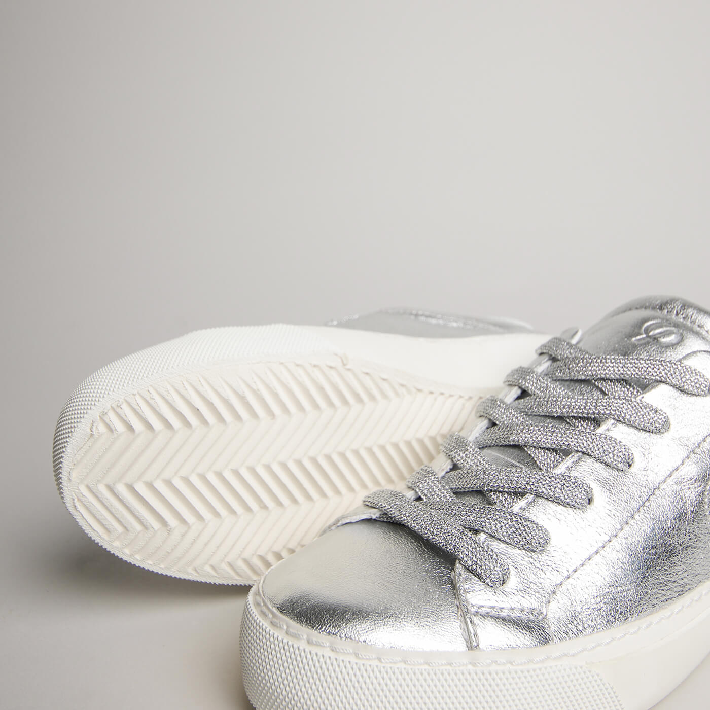 Close-up of silver goat leather, laces and herringbone outsole on the women’s Milano