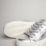Close-up of silver goat leather, laces and herringbone outsole on the women’s Milano