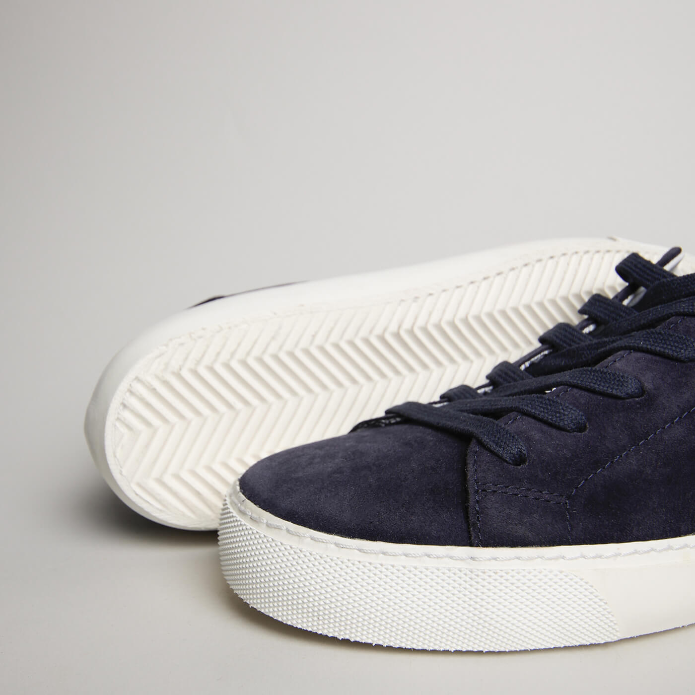 Close-up of navy blue suede, laces and herringbone outsole on the men’s Milano