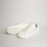 Angled pair of men’s white tumbled leather Milano sneakers with herringbone outsoles