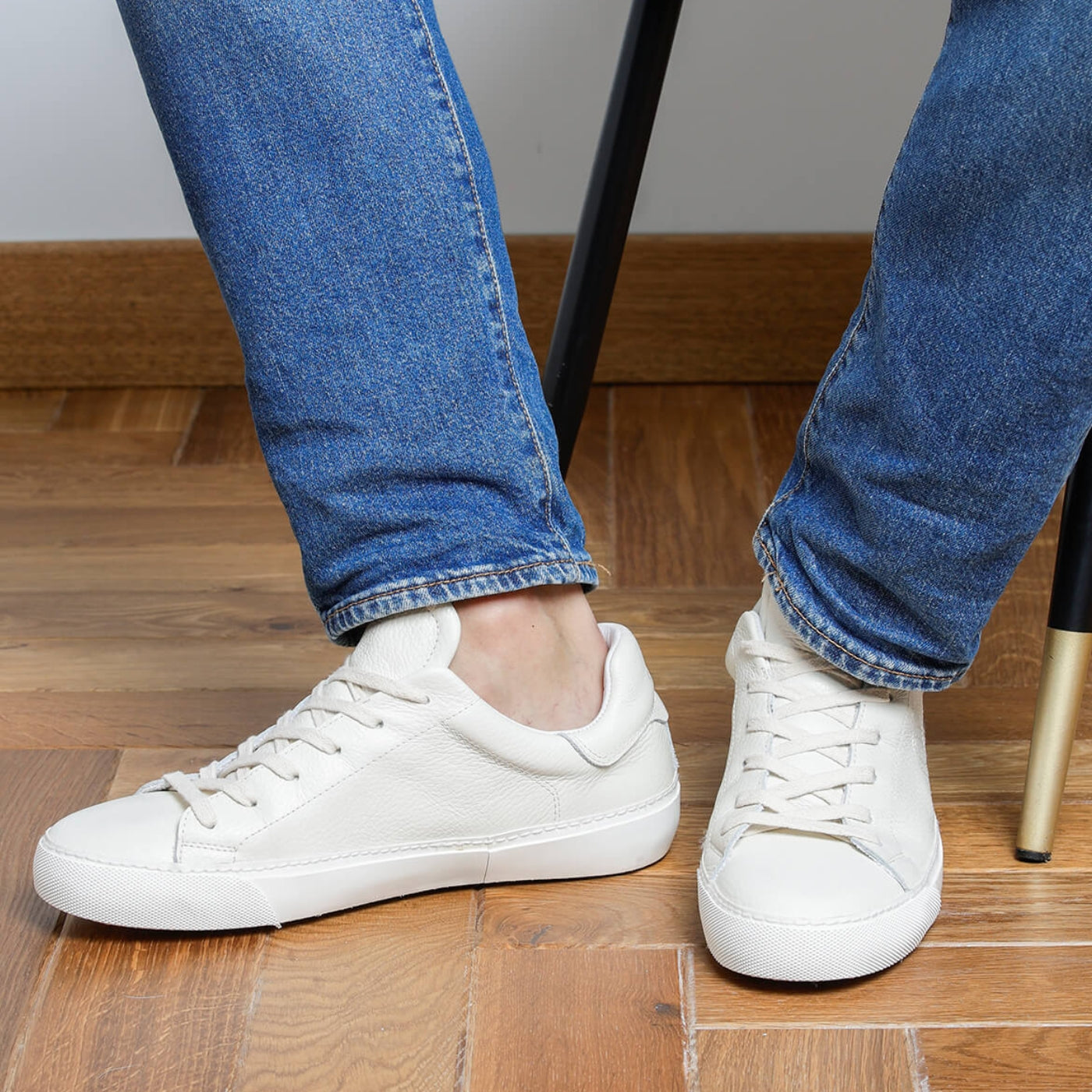 Man wearing white tumbled leather Milano sneakers, front view