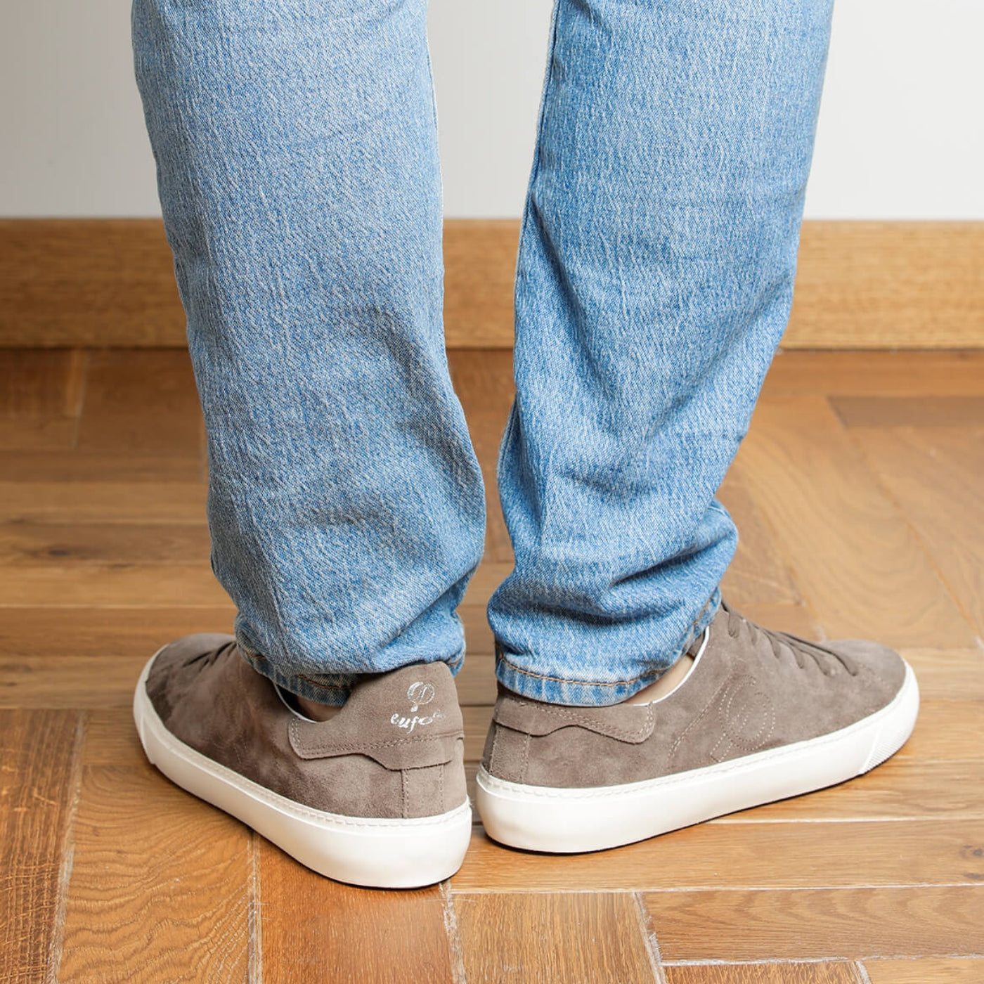 Man wearing dark taupe suede Milano sneakers, rear view