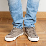 Man wearing dark taupe suede Milano sneakers, front view