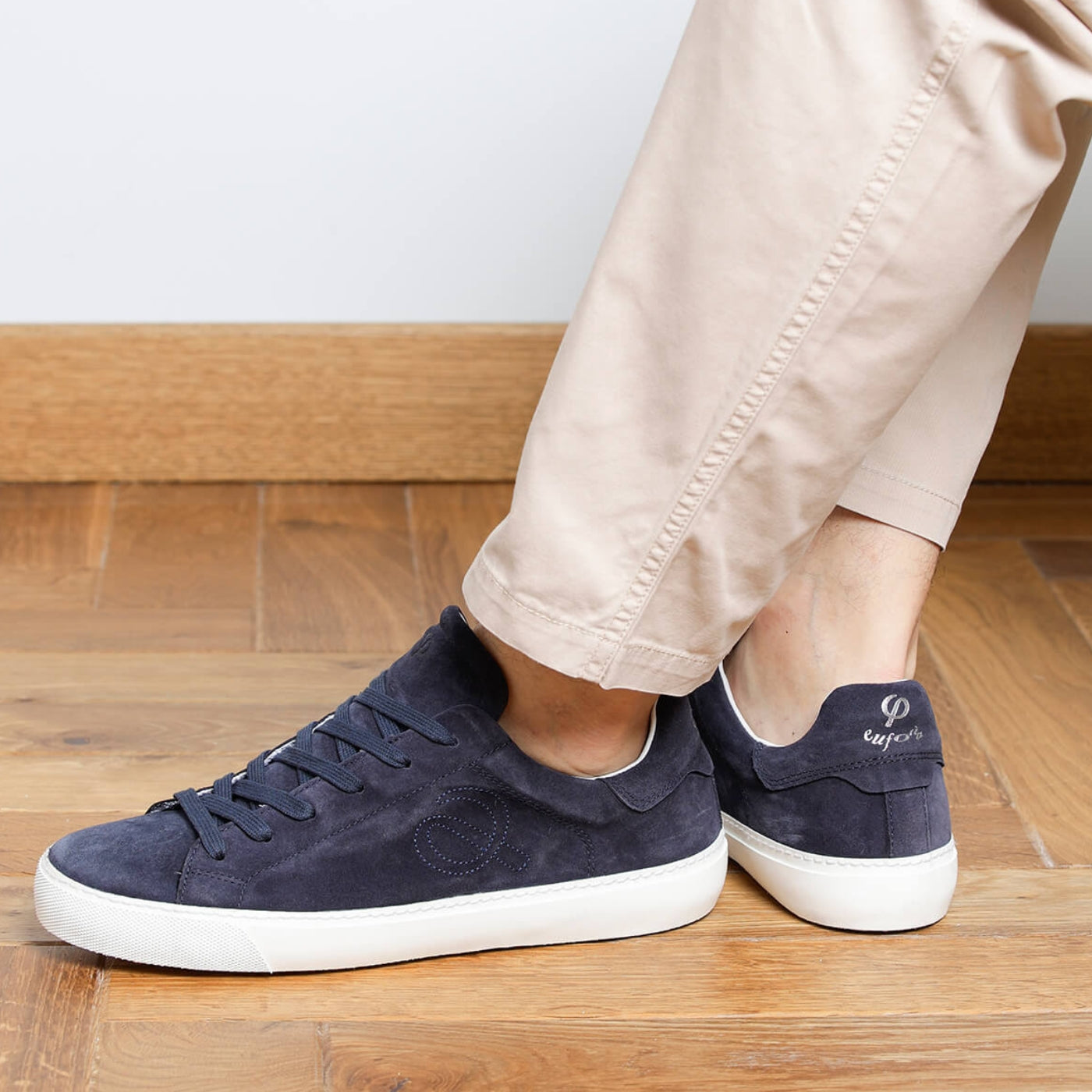 Man wearing navy blue suede Milano sneakers, side view