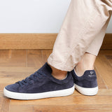 Man wearing navy blue suede Milano sneakers, side view